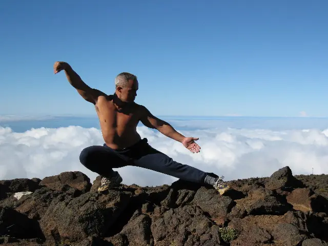 Karol Krauser practicing Tai Chi on Haleakala mountain above the clouds in Hawaii