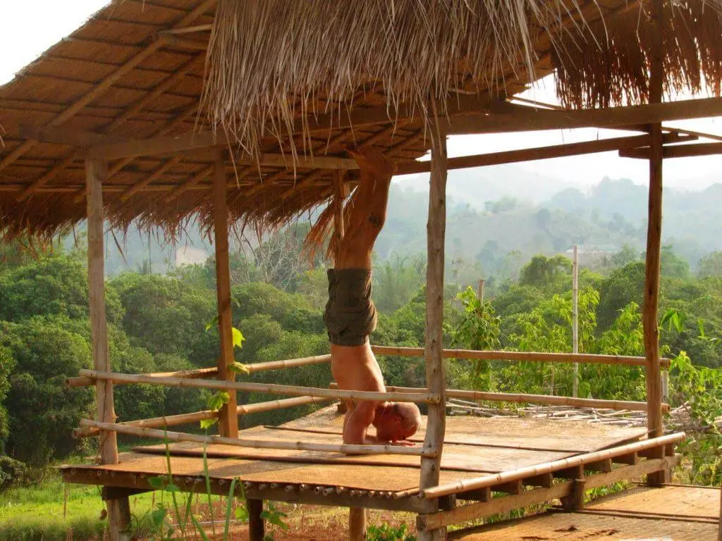 Karol Krauser doing yoga headstand in Asia